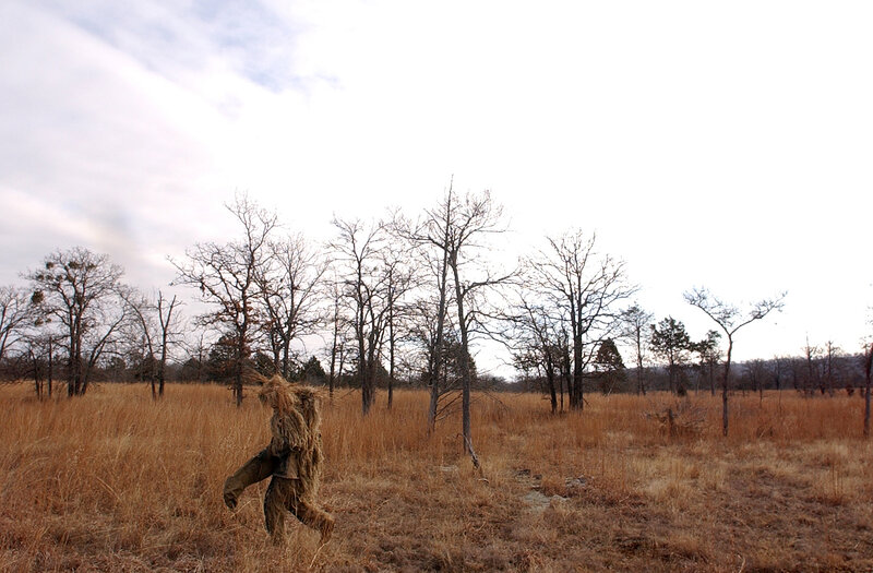 person in ghillie suit walking
