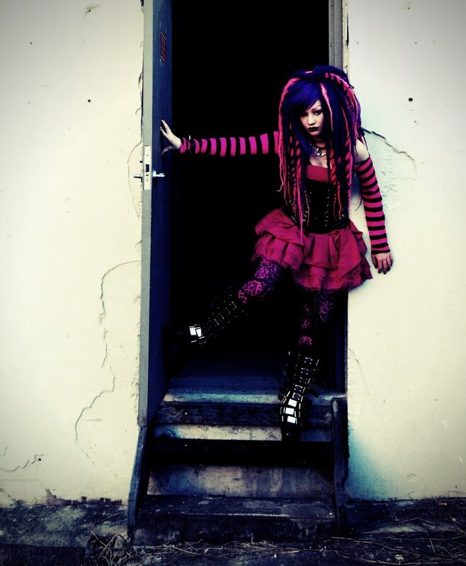 person in goth outfit at doorway