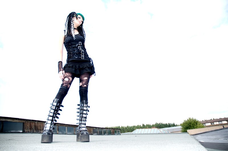 person in goth outfit on rooftop