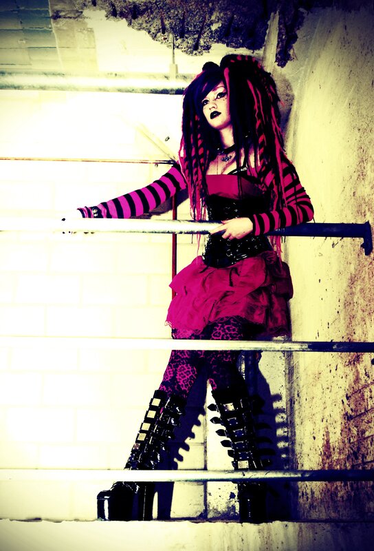 person in goth outfit on stairs
