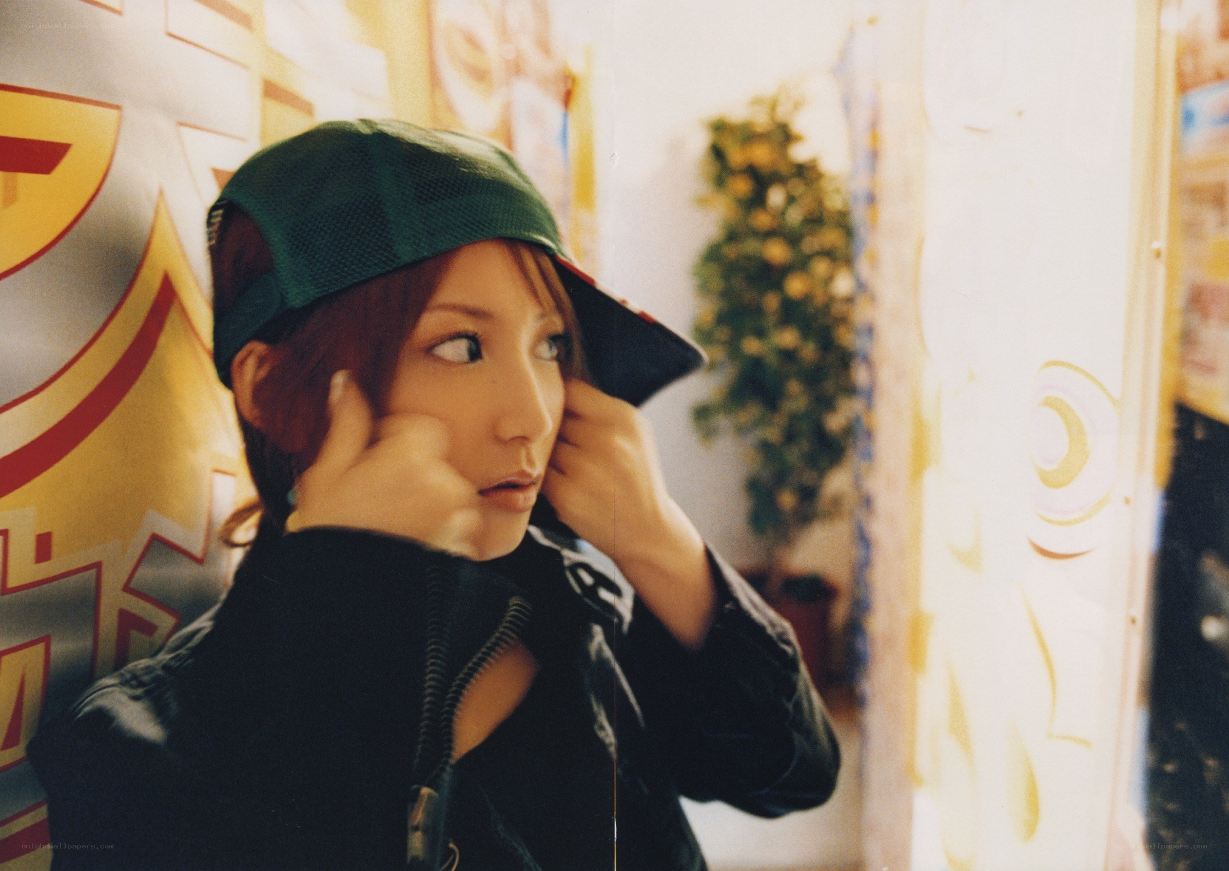 person in green cap adjusting ears