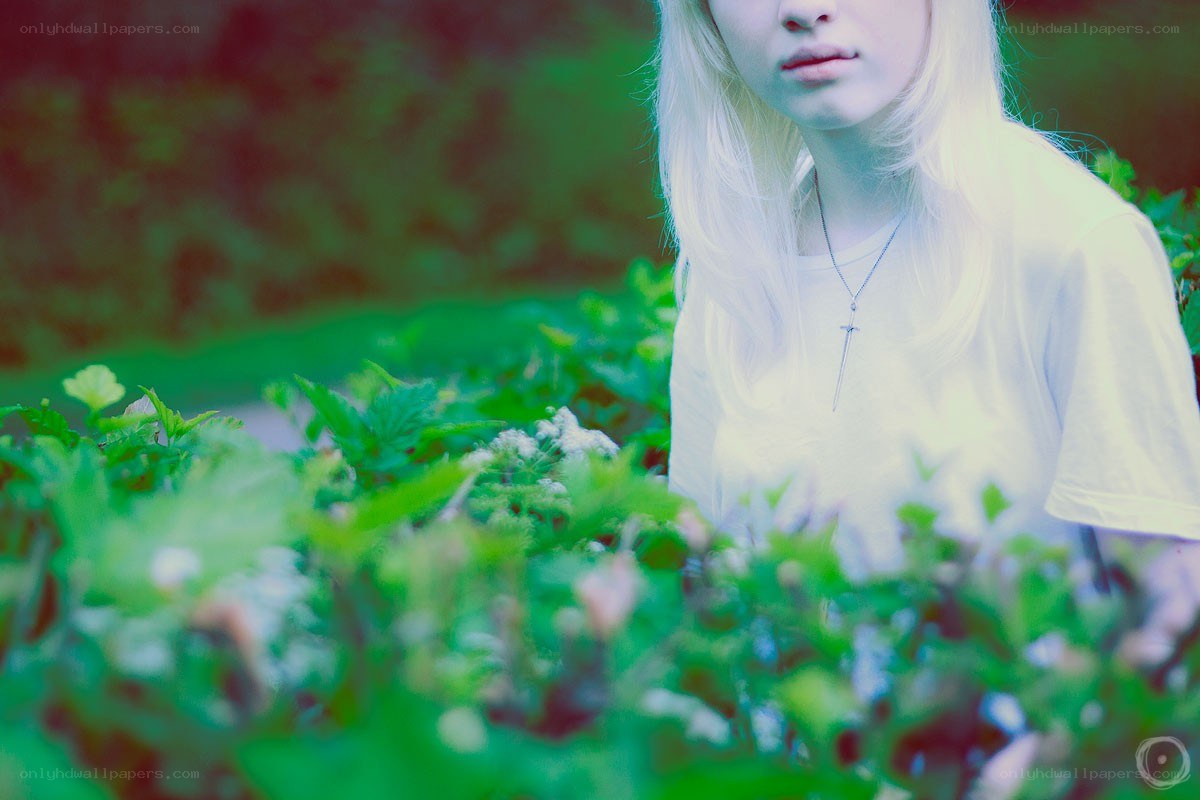 person in green foliage