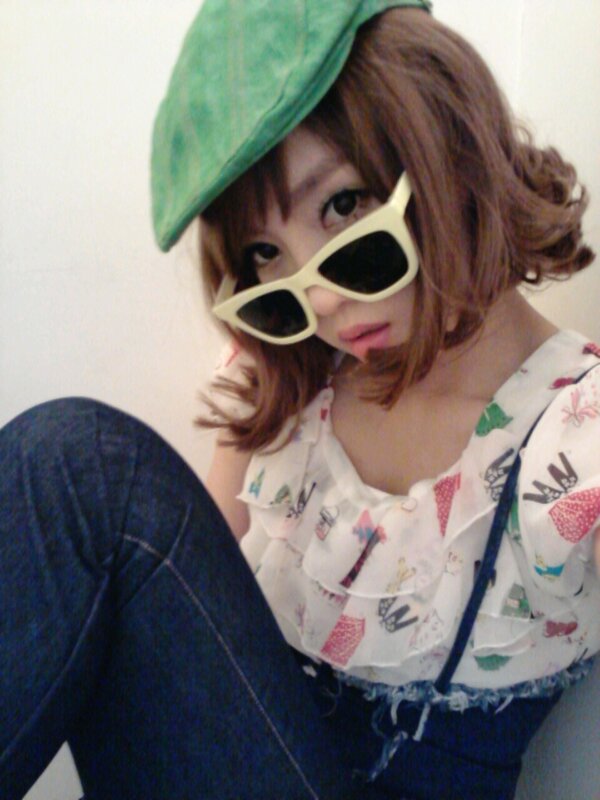 person in green hat and sunglasses