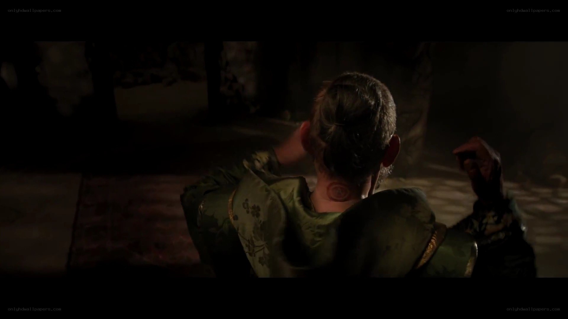 person in green robe from behind
