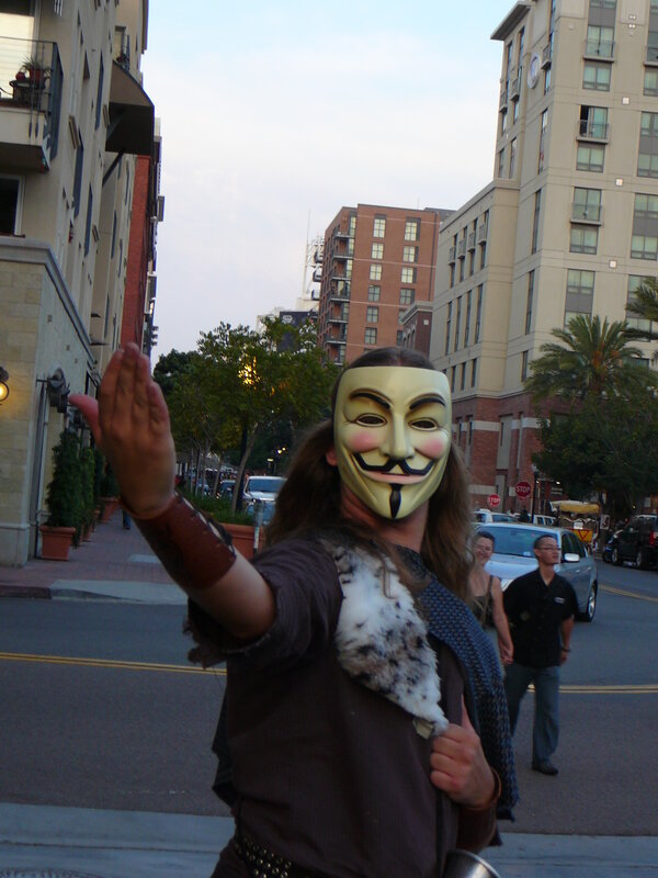 person in guy fawkes mask on street