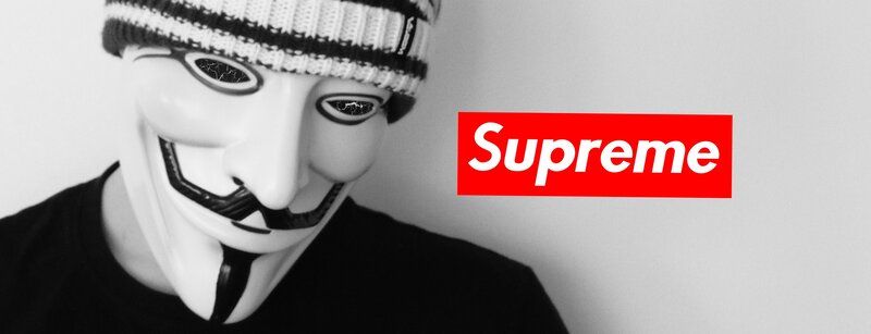 person in guy fawkes mask with supreme logo