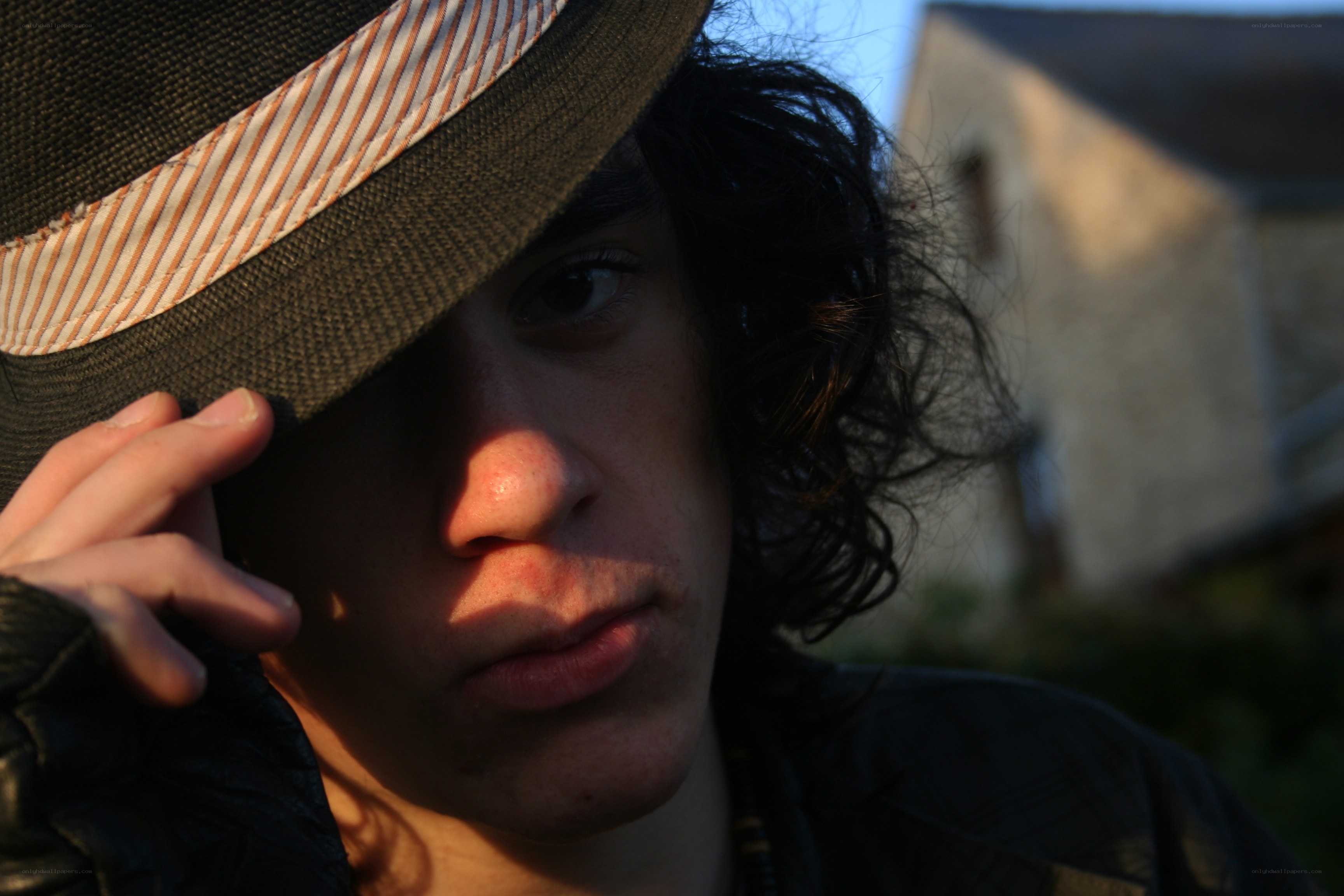 person in hat at sunset