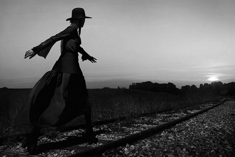 Person in Hat on Train Tracks