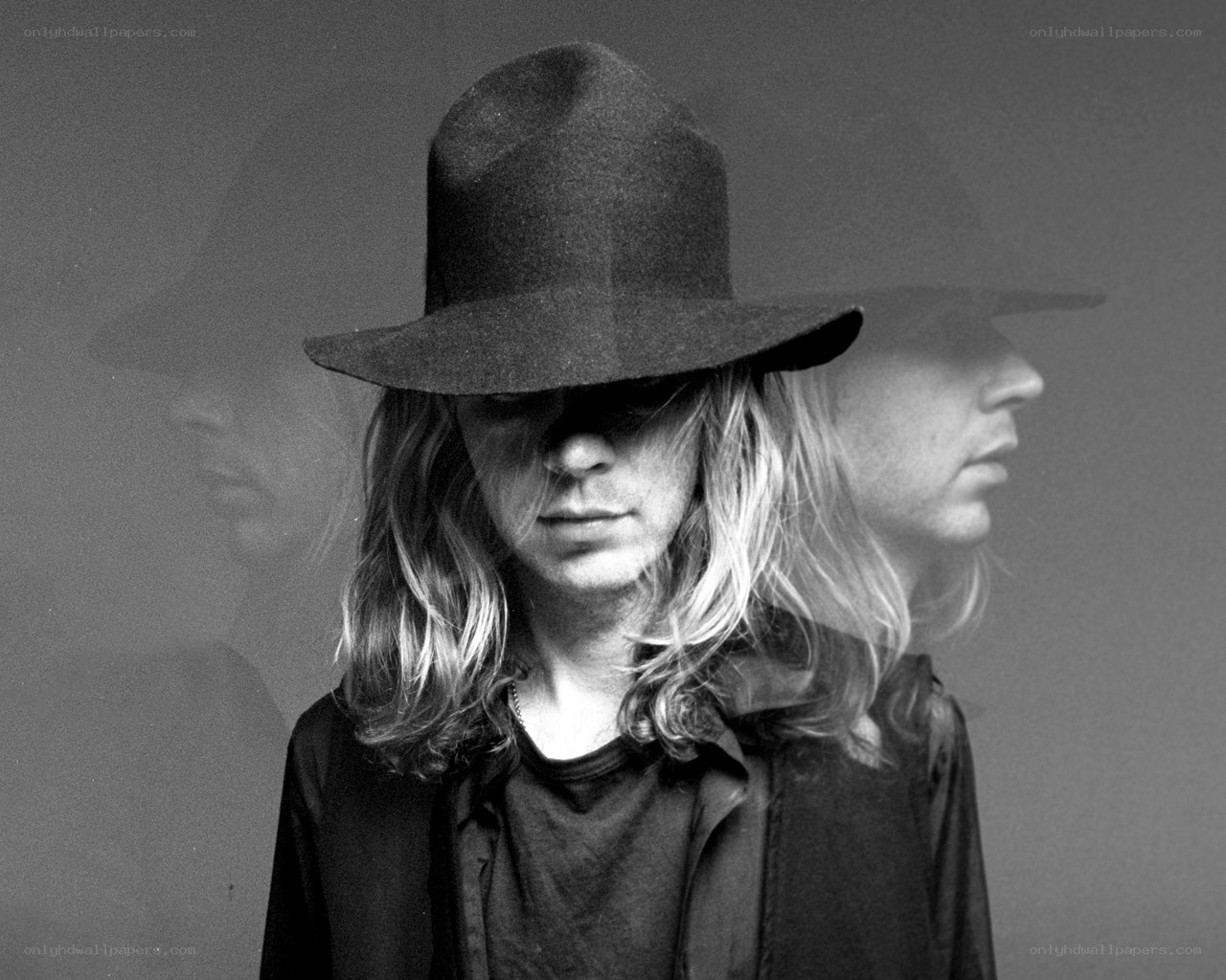 person in hat with double exposure