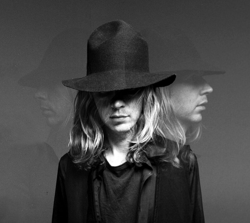 person in hat with long hair