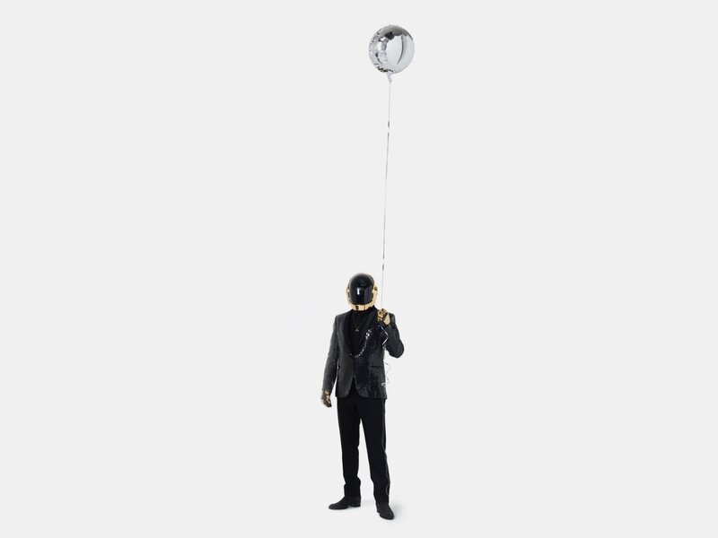 Person in helmet holding balloon