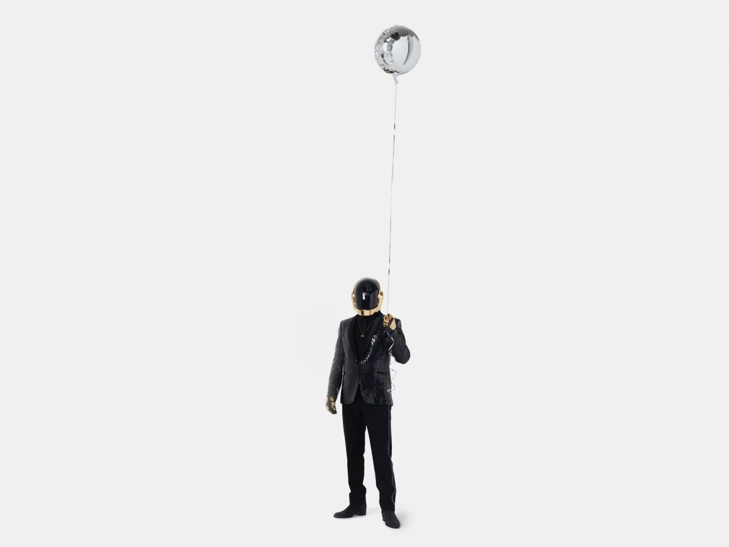 Person in helmet holding balloon