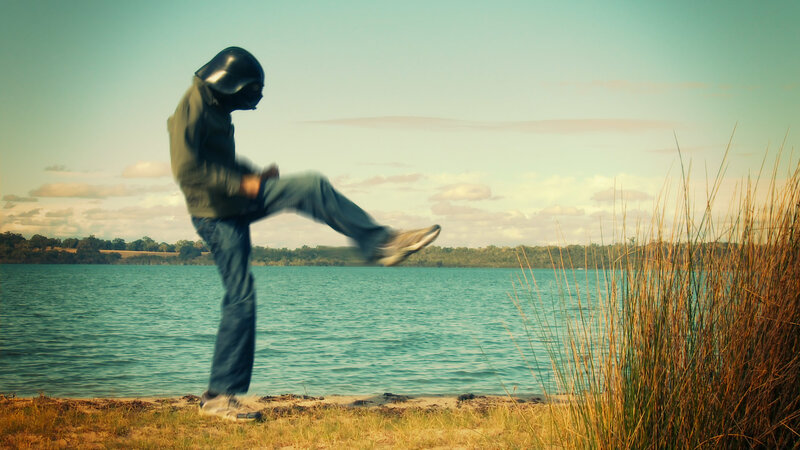 person in helmet near lake