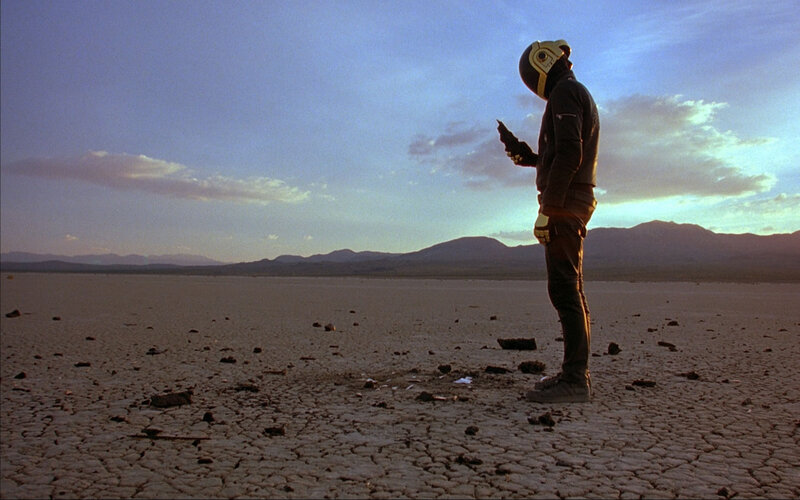 person in helmet on cracked earth
