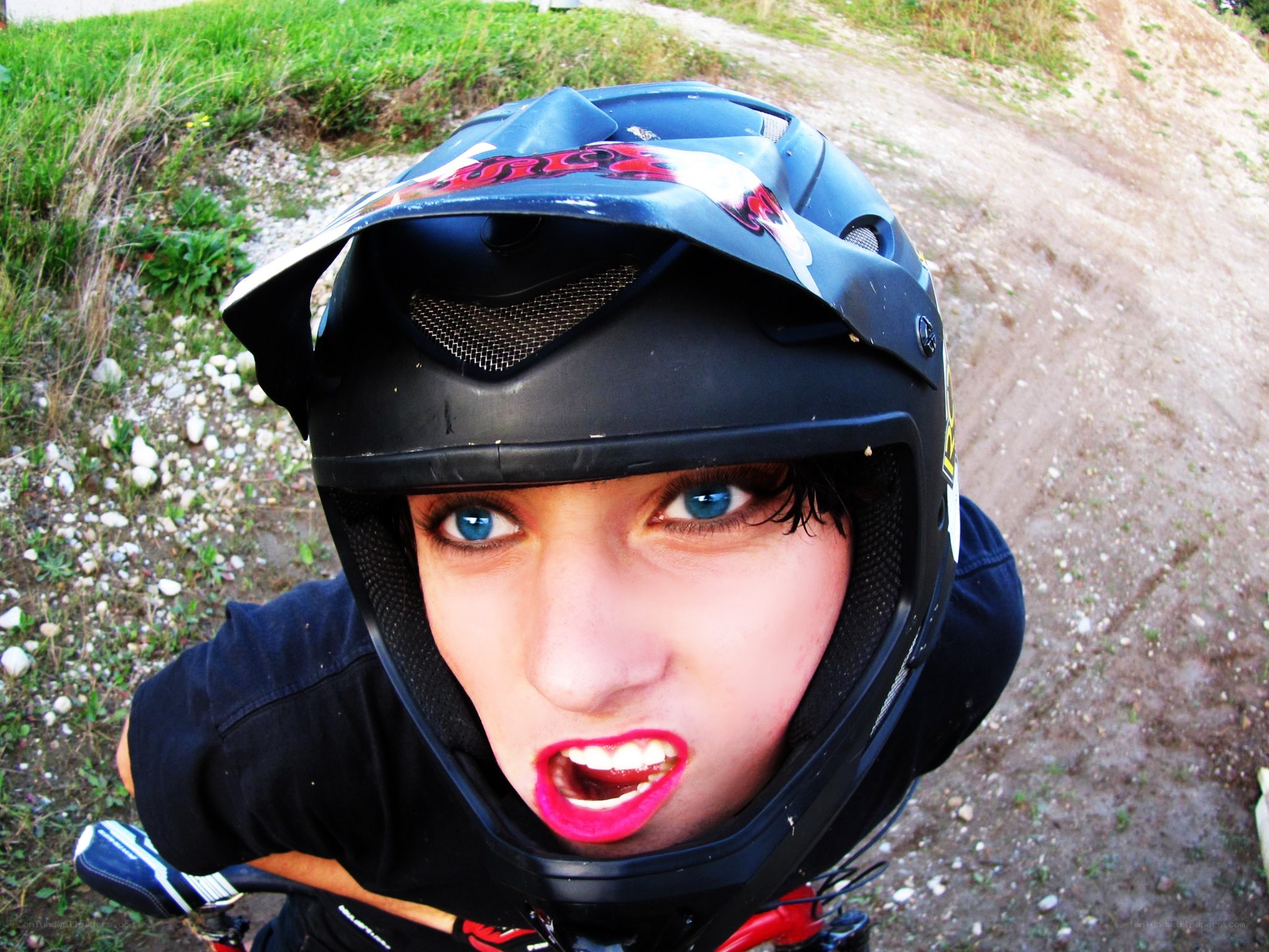 person in helmet on dirt path