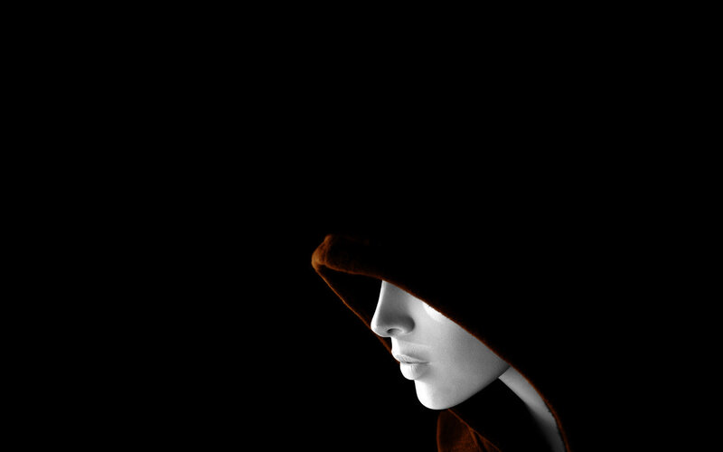 person in hooded cloak