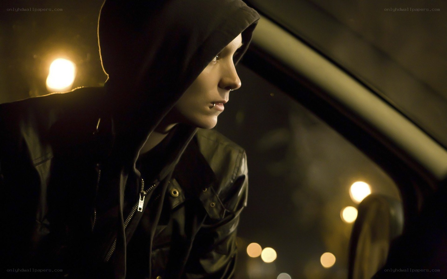 person in hooded jacket at night