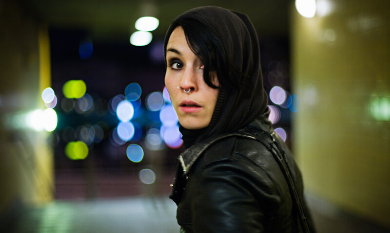 person in hooded jacket at night