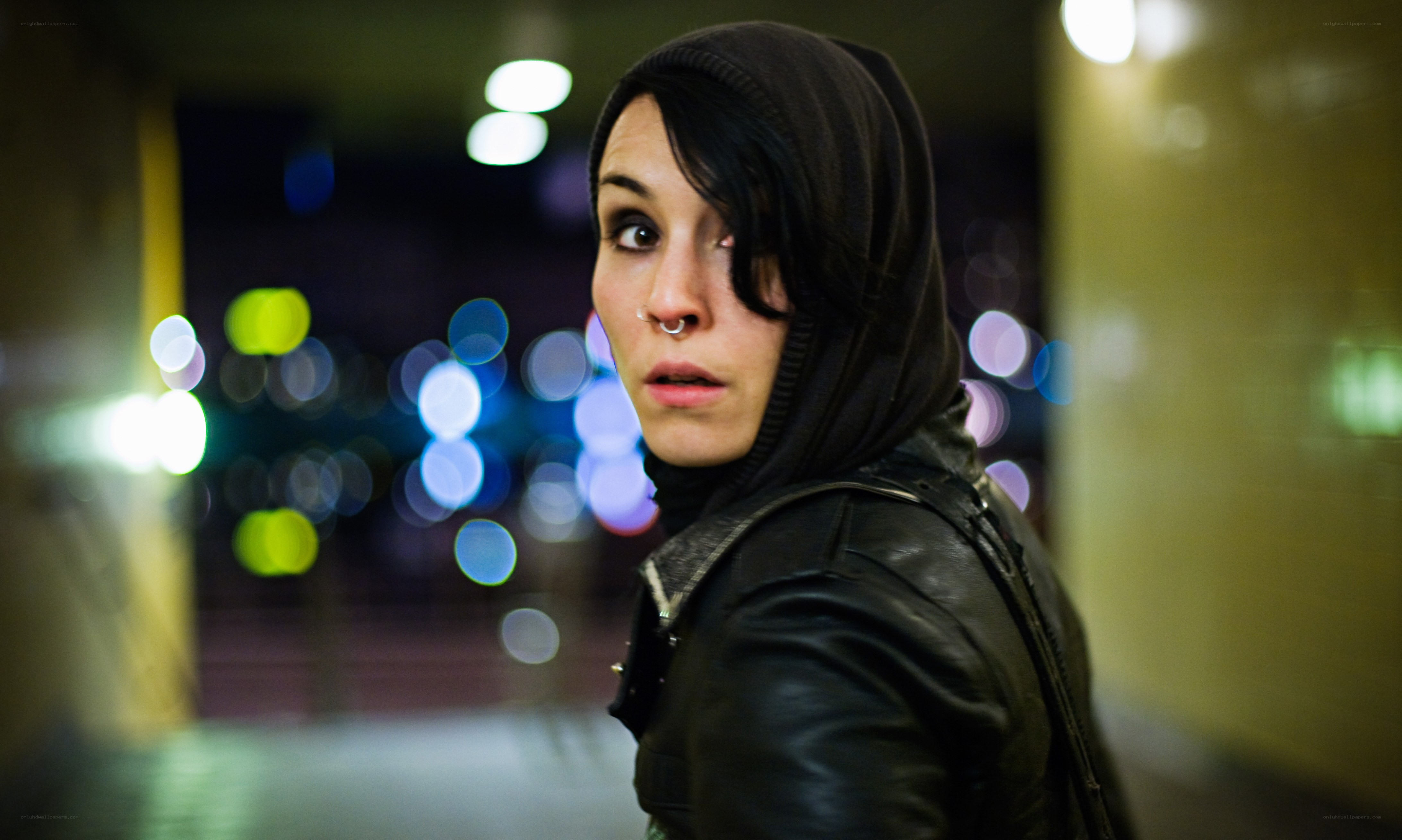 person in hooded jacket at night