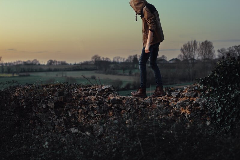 Person in Hooded Jacket — Brown, Contemplative