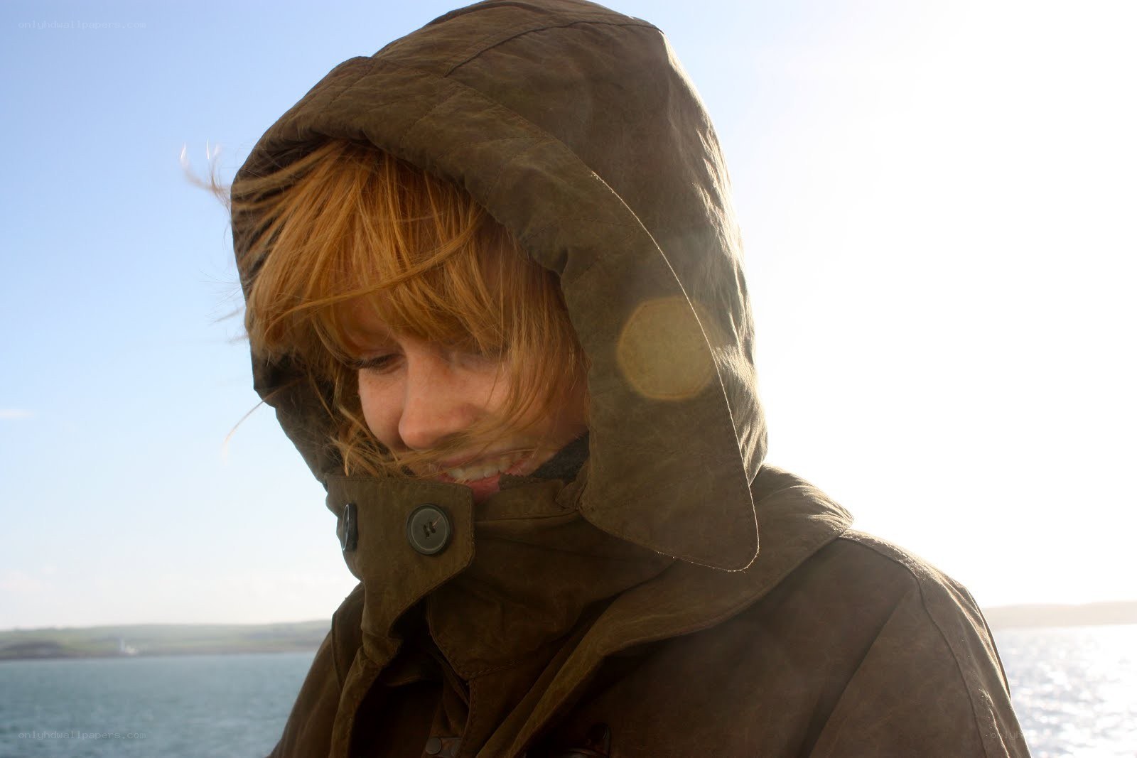 person in hooded jacket by water