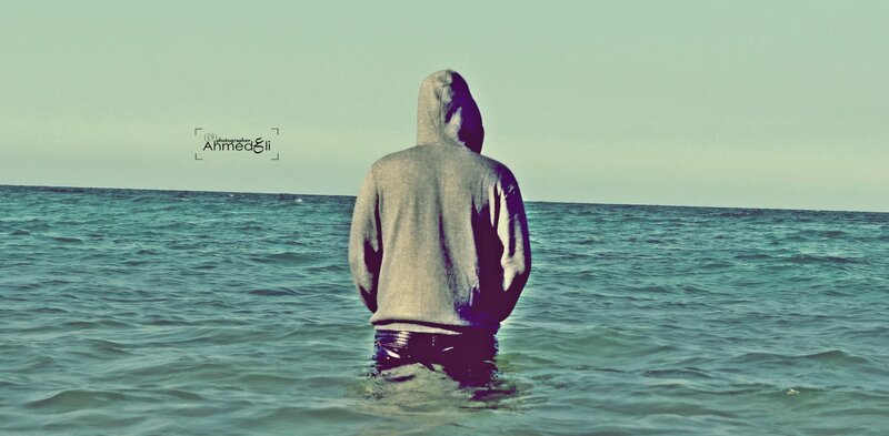 person in hoodie at sea
