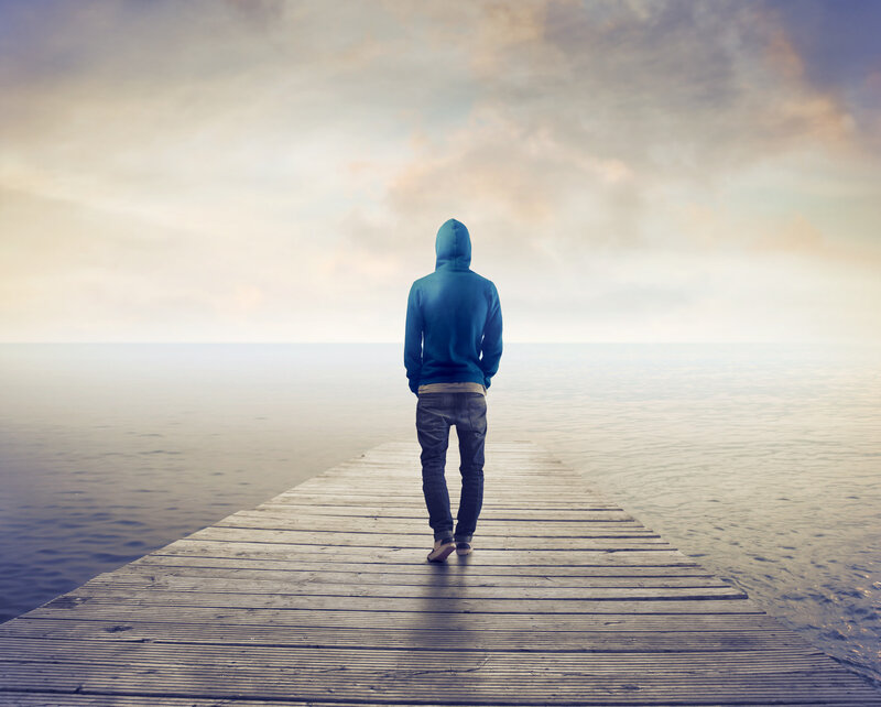 Person in Hoodie on Pier