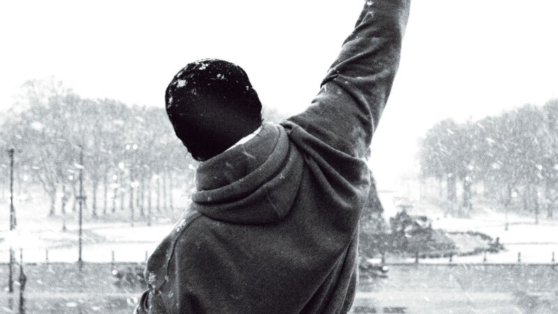 Person in Hoodie Raising Arm