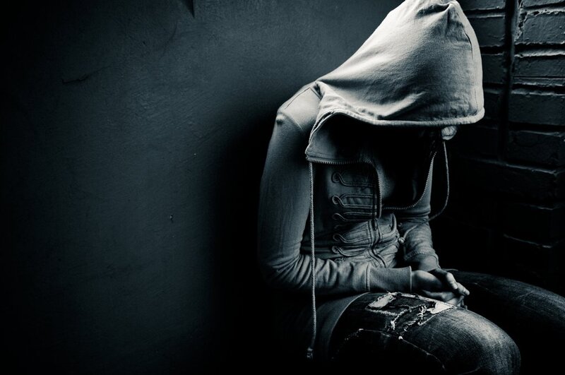 Person in Hoodie Sitting — Black