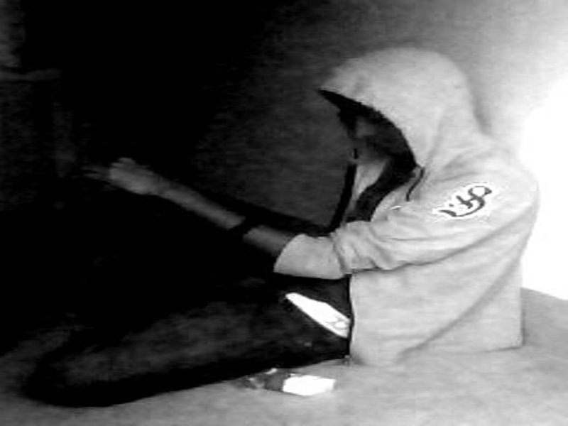 Person in Hoodie Sitting