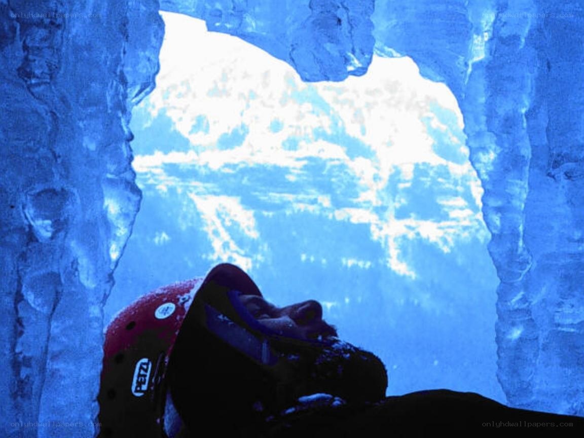 Person in ice cave looking up