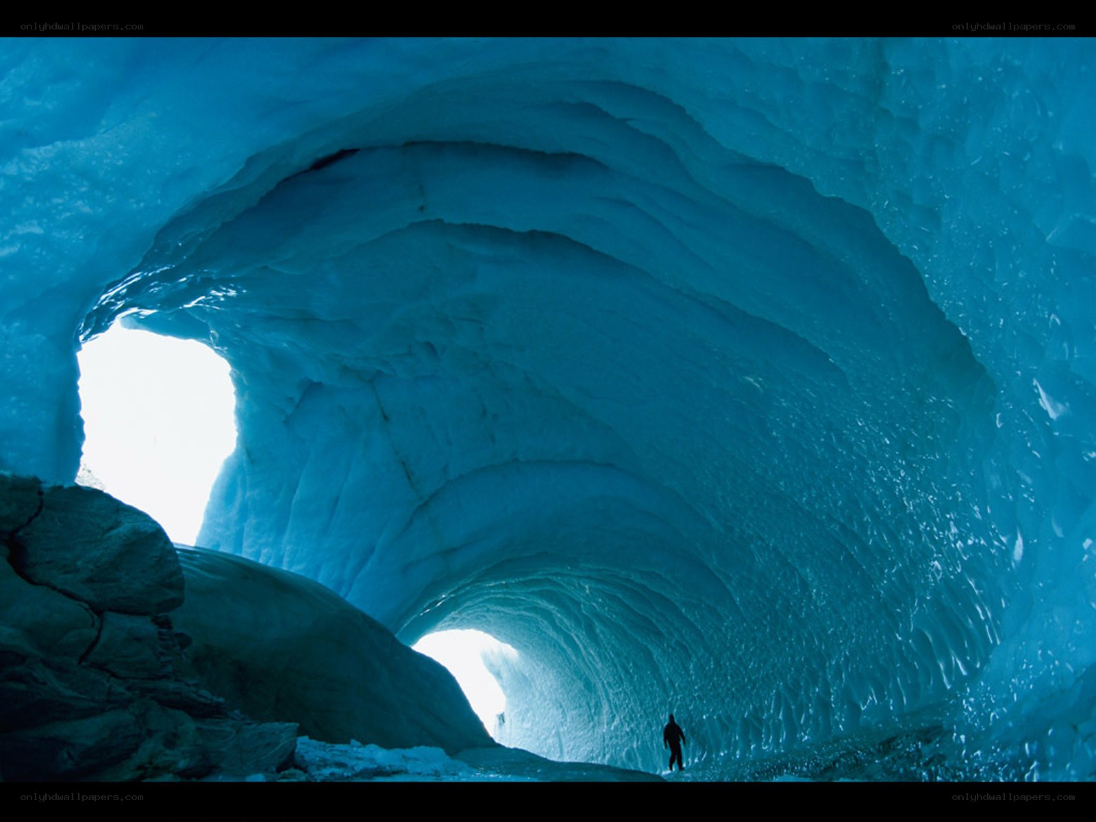 Person in ice cave tunnel