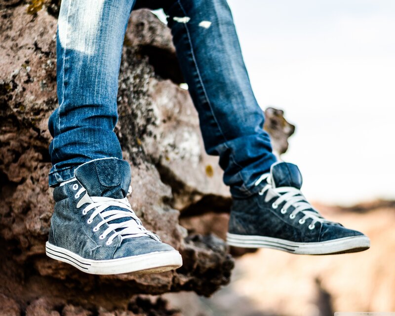 person in jeans and sneakers