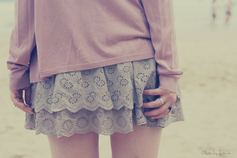 person in lace skirt at beach