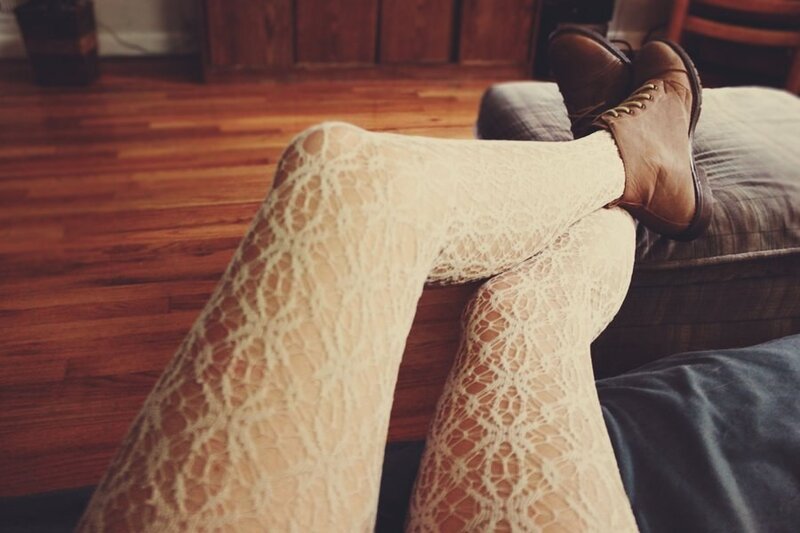 person in lace tights and boots