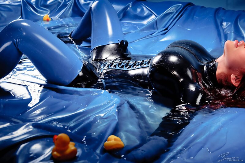 person in latex suit in water