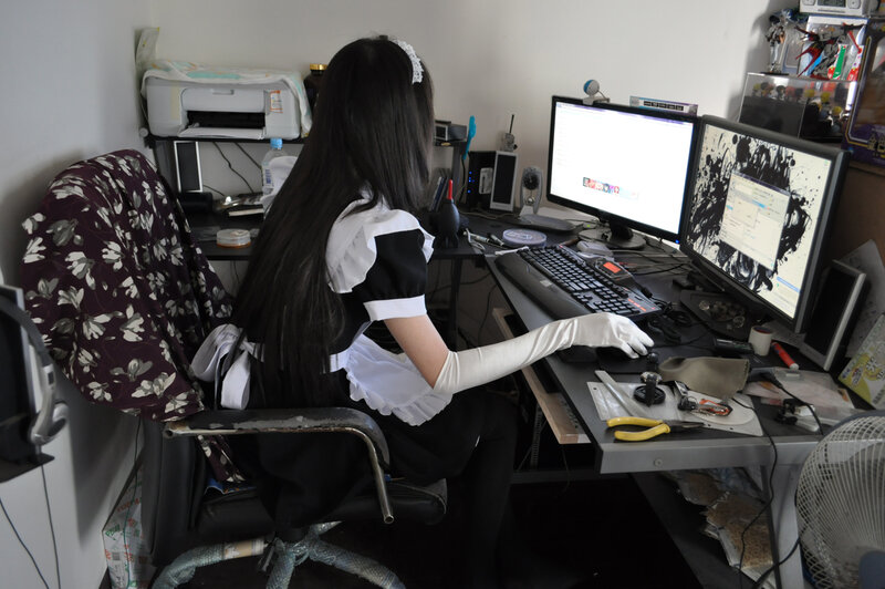 person in maid outfit at computer