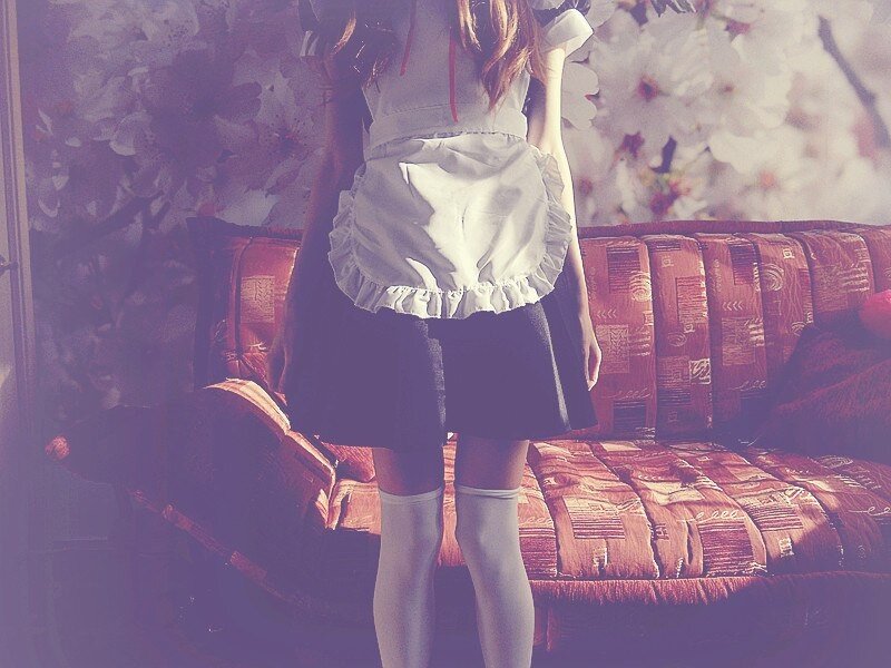 person in maid outfit standing