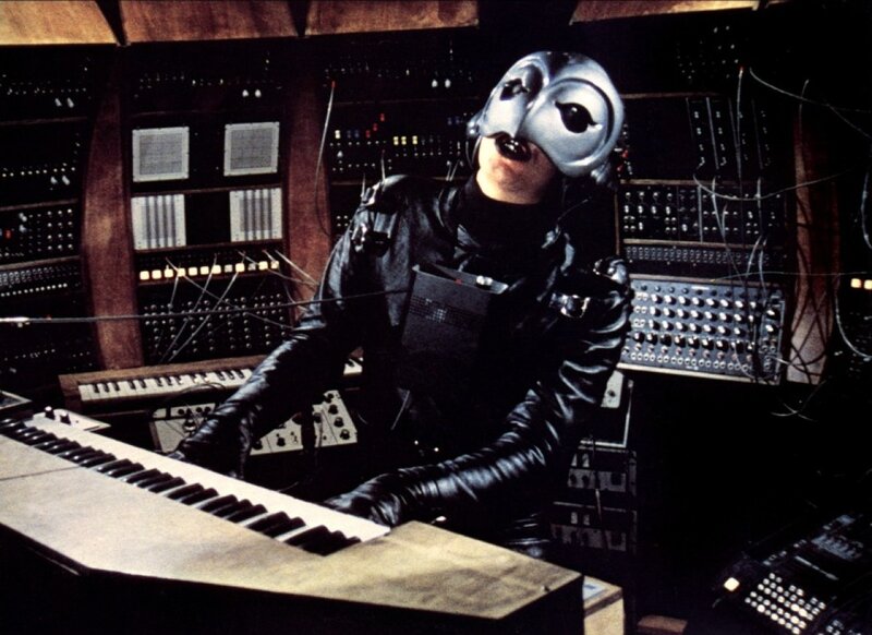 person in mask at keyboard