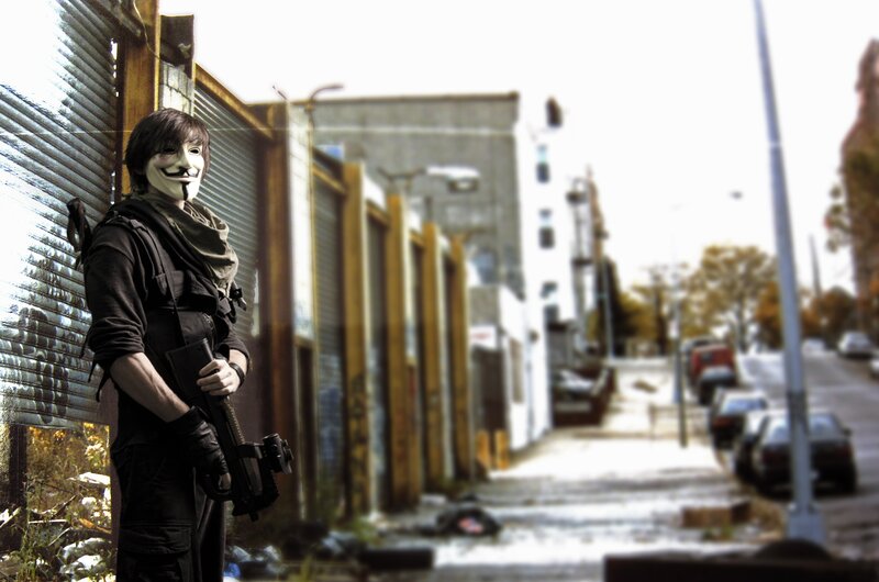 person in mask holding rifle