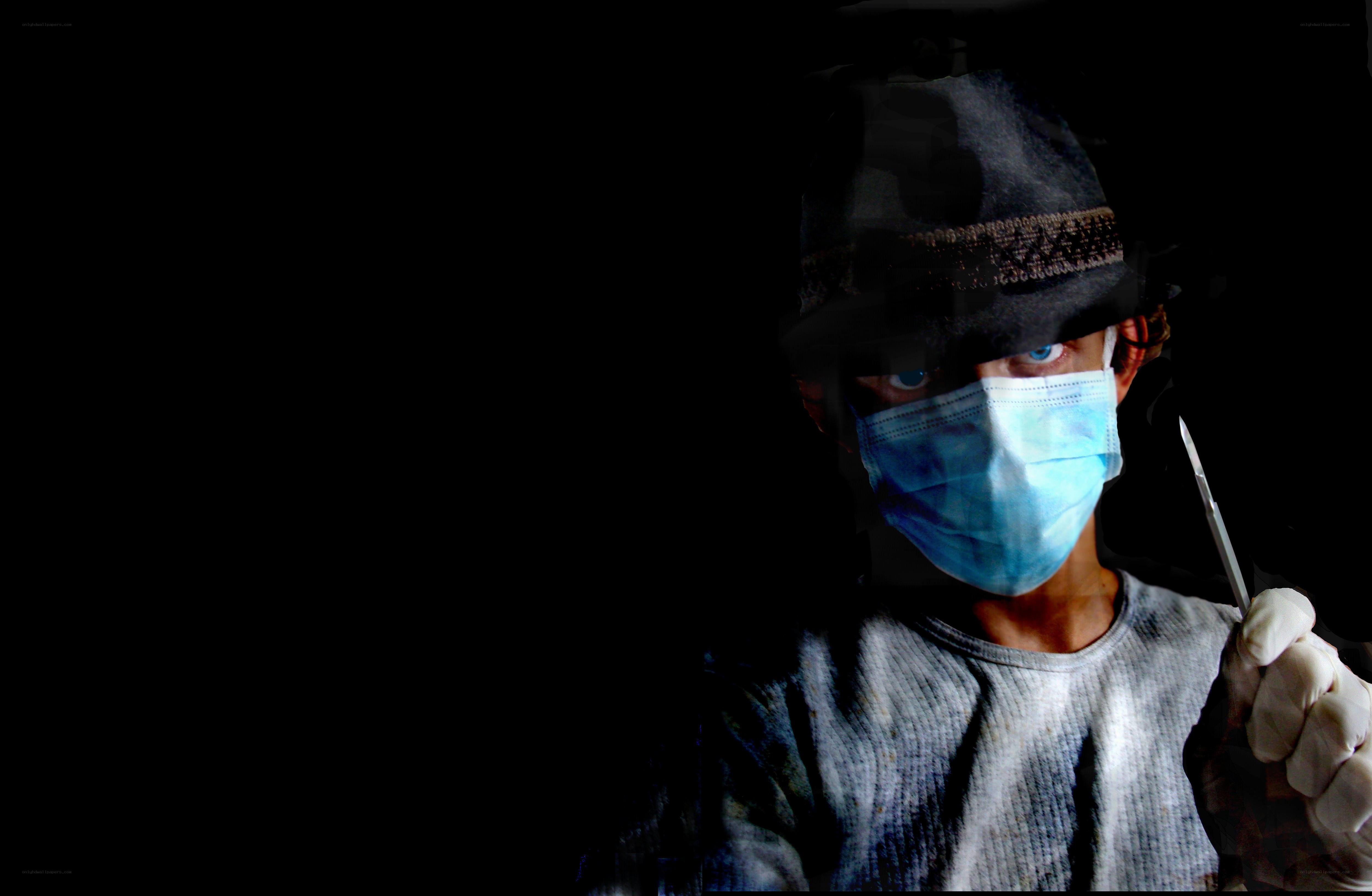 person in mask holding scissors