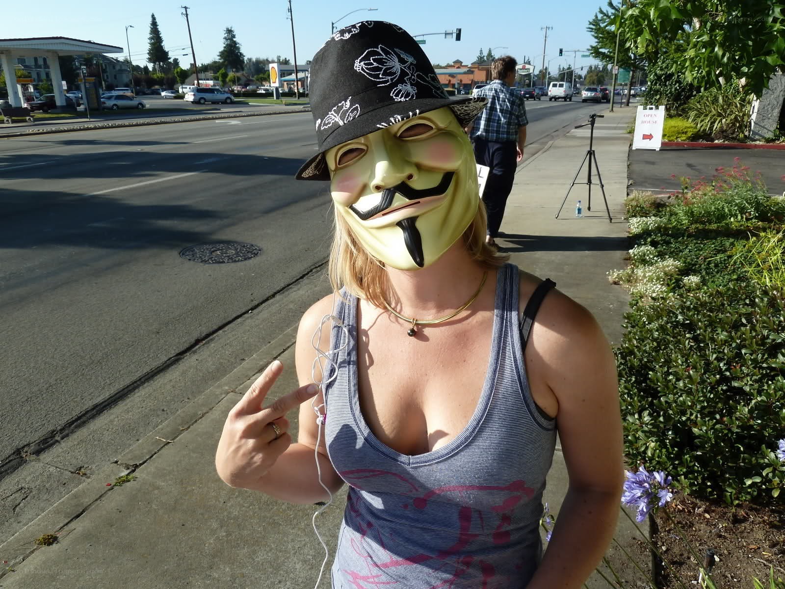 person in mask on sidewalk