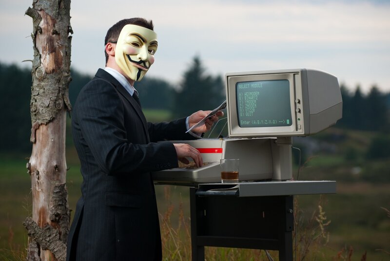 person in mask using computer