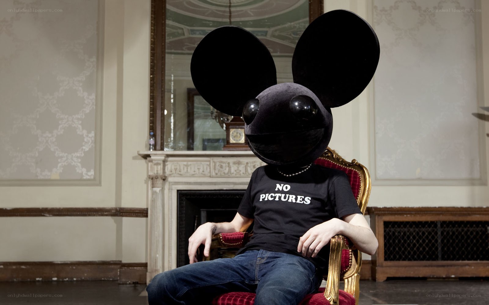 Person in mouse mask sitting
