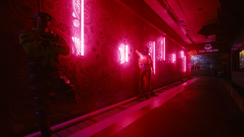 Person in Neon-lit Corridor