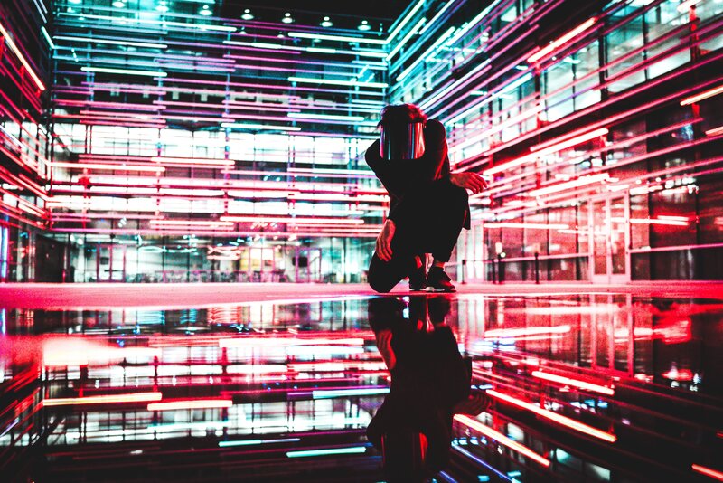 person in neon-lit space