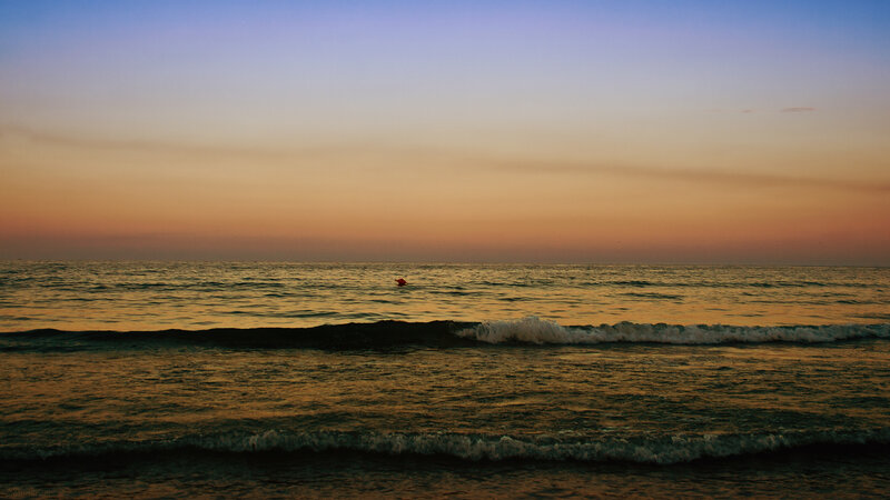 Person in Ocean at Sunset — Orange, Serene