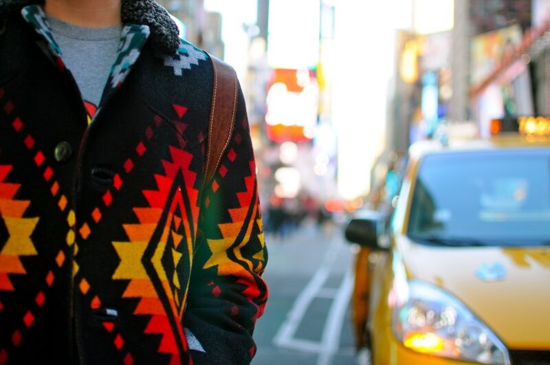 Person in Patterned Coat — Black