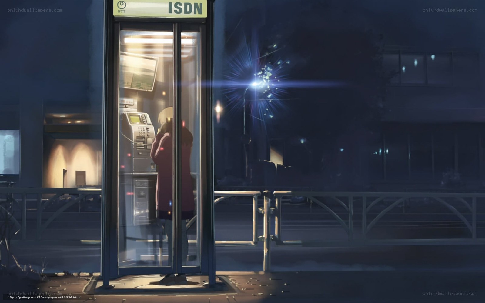 person in phone booth at night