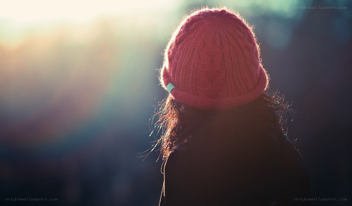 person in pink beanie at sunset